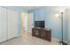 Bedroom with a TV, closet, and floor lamp at 3090 Tioga Ter, Deltona, FL 32738