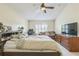 Main bedroom with a large bed, dresser, and flat-screen TV at 3090 Tioga Ter, Deltona, FL 32738