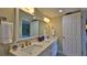 Bathroom with double vanity and large mirror at 5207 S Atlantic Ave # 1226, New Smyrna Beach, FL 32169