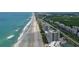 Aerial view of beachfront high rise building with beach and road access at 5207 S Atlantic Ave # 1226, New Smyrna Beach, FL 32169