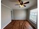 Bright bedroom with wood-look flooring, ceiling fan, and large window at 1614 Shady Ridge Ct # 252, Orlando, FL 32807