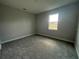 Well-lit bedroom featuring neutral walls and carpet at 3260 Roseville Dr, Apopka, FL 32712