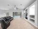 Living room with a black sectional sofa and built-in shelving, overlooking the pool at 25013 Derby Dr, Sorrento, FL 32776