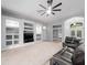 Living room boasts built-in shelving and a ceiling fan at 25013 Derby Dr, Sorrento, FL 32776