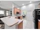 Kitchen features a large island, stainless steel appliances, and light wood cabinets at 25013 Derby Dr, Sorrento, FL 32776