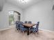 Bright dining room features a wood table with blue patterned chairs at 25013 Derby Dr, Sorrento, FL 32776