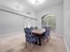 Spacious dining room with a wooden table and blue chairs, near the entryway at 25013 Derby Dr, Sorrento, FL 32776
