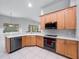 Modern kitchen with stainless steel appliances and light wood cabinets at 25013 Derby Dr, Sorrento, FL 32776