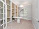Home office with built-in bookshelves and a desk at 25013 Derby Dr, Sorrento, FL 32776