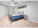 Main bedroom with metal bed frame and neutral wall color at 25013 Derby Dr, Sorrento, FL 32776