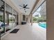 Spacious pool area with covered patio and sliding glass doors at 25013 Derby Dr, Sorrento, FL 32776