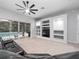 Spacious living room with a black sectional sofa and pool view at 25013 Derby Dr, Sorrento, FL 32776