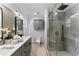 Modern bathroom with gray vanity, double sinks, and a glass shower at 1616 E Marks St, Orlando, FL 32803