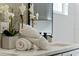 Bathroom detail of vanity with white marble countertop and rolled towels at 1616 E Marks St, Orlando, FL 32803