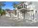 Two-car garage with paver driveway and private balcony above at 1616 E Marks St, Orlando, FL 32803