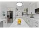Updated kitchen with white cabinets, marble backsplash, and large island at 1616 E Marks St, Orlando, FL 32803