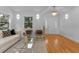 Open concept living room with hardwood floors and access to front entry at 1616 E Marks St, Orlando, FL 32803