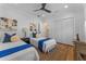 Bright bedroom with two twin beds, a ceiling fan, and hardwood floors at 1616 E Marks St, Orlando, FL 32803