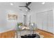 Home office with glass desk, hardwood floors, and built-in shelving at 1616 E Marks St, Orlando, FL 32803