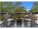 Private balcony with wicker chairs and a small table, overlooking trees at 1616 E Marks St, Orlando, FL 32803