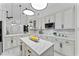 Modern kitchen with white cabinets, marble countertops, and a spacious island at 1616 E Marks St, Orlando, FL 32803
