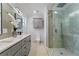 Updated bathroom with gray vanity, double sinks, and glass shower at 1616 E Marks St, Orlando, FL 32803