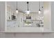 Modern kitchen with white cabinets, marble counters, and a large island at 1616 E Marks St, Orlando, FL 32803