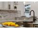 Close-up of a kitchen sink and faucet with marble backsplash at 1616 E Marks St, Orlando, FL 32803