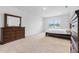 Bedroom with dresser and window overlooking trees at 821 Sun Burst Rd, Winter Haven, FL 33880