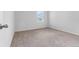 Simple carpeted bedroom with a window and neutral walls at 821 Sun Burst Rd, Winter Haven, FL 33880