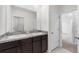Double vanity bathroom with granite countertops and a view of a hallway at 821 Sun Burst Rd, Winter Haven, FL 33880