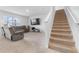 Living room with gray couch, stairs, and TV at 821 Sun Burst Rd, Winter Haven, FL 33880