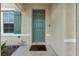 Teal front door with welcome mat and star decor at 821 Sun Burst Rd, Winter Haven, FL 33880