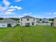 Large backyard with a view of neighboring houses at 821 Sun Burst Rd, Winter Haven, FL 33880