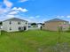 Large backyard with two houses visible in the background at 821 Sun Burst Rd, Winter Haven, FL 33880