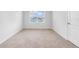 Simple bedroom with carpeted floor and a window at 821 Sun Burst Rd, Winter Haven, FL 33880