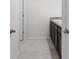 Clean bathroom with double vanity and dark brown cabinets at 821 Sun Burst Rd, Winter Haven, FL 33880