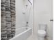 Bathroom with shower/tub combo, toilet and patterned shower curtain at 821 Sun Burst Rd, Winter Haven, FL 33880