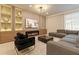 Living room featuring a sectional sofa, fireplace, and built-in shelving at 3625 Lily Ln, Davenport, FL 33897