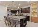 Kitchen with granite countertops, dark cabinets and island with seating at 3625 Lily Ln, Davenport, FL 33897