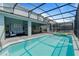 Private screened-in pool and spa with plenty of lounge chairs at 3625 Lily Ln, Davenport, FL 33897