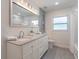 Elegant bathroom with double vanity, granite countertop, and large mirror at 905 Marabon Ave, Orlando, FL 32806