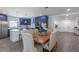 Kitchen and dining area with wood table, navy cabinets and hardwood floors at 905 Marabon Ave, Orlando, FL 32806