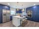 Modern kitchen with navy blue cabinetry, quartz countertops, and stainless steel appliances at 905 Marabon Ave, Orlando, FL 32806