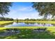 Serene pond with benches, offering a peaceful community amenity at 1831 Waterside Oaks Dr, Orange City, FL 32763