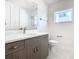 Simple bathroom with wood-look vanity and white quartz countertop at 1020 Jack Nicklaus Ct, Kissimmee, FL 34747