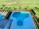 Luxury pool and spa with spacious patio, overlooking a golf course at 1020 Jack Nicklaus Ct, Kissimmee, FL 34747
