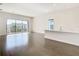 Bright and airy living room with dark hardwood floors and access to a balcony at 1020 Jack Nicklaus Ct, Kissimmee, FL 34747