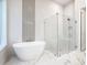 Spa-like bathroom with a freestanding soaking tub and a walk-in shower at 1020 Jack Nicklaus Ct, Kissimmee, FL 34747
