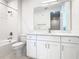 Modern bathroom with white cabinets and a large mirror at 1020 Jack Nicklaus Ct, Kissimmee, FL 34747